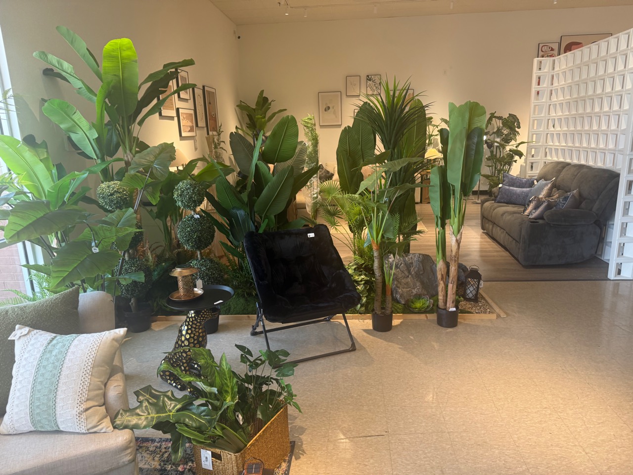 Layered home setting with greenery, decor, seating, and textiles